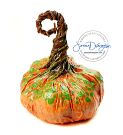 Jessica Dvergsten paper mache orange pumpkin with green polka dots for Halloween or Thanksgiving decorations.